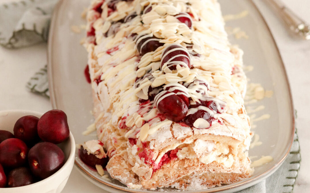 Chilled Almond Meringue Roulade filled with Fresh Cherries and Cream
